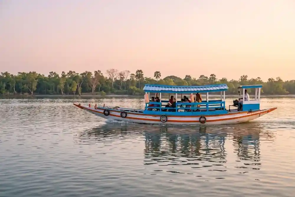 Tourist boat safari cruising through beautiful Sundarban mangrove river during jungle tour
