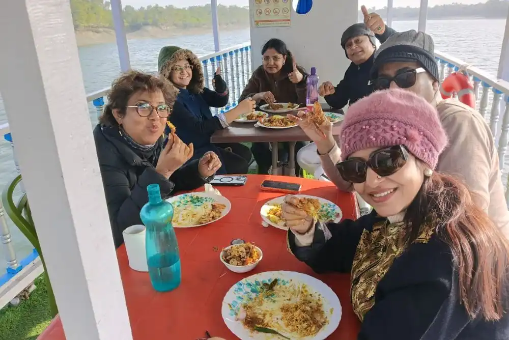 Tourists enjoying hygienic food on boat during Sundarban one day tour safari